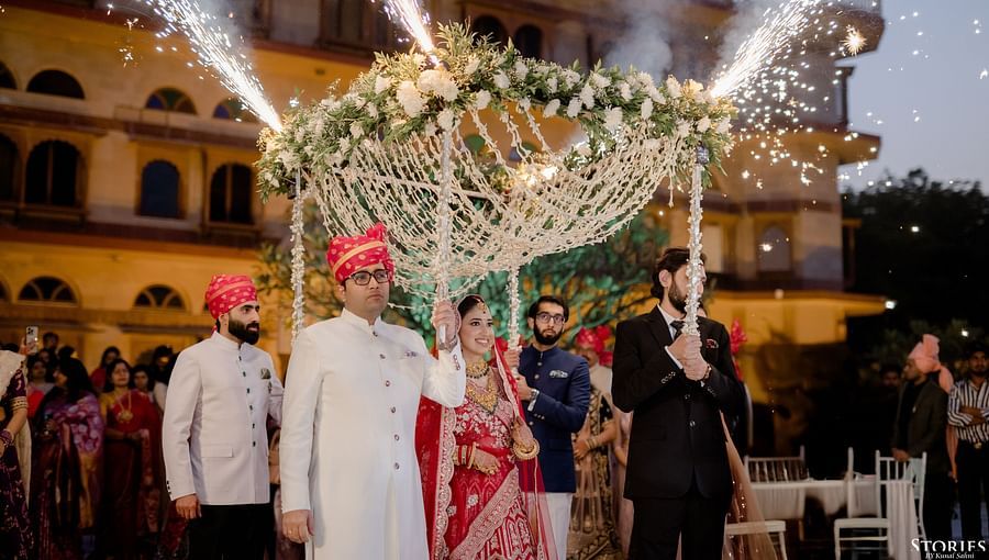 Groom’s procession under a canopy of lights in front of Umaid Palace.