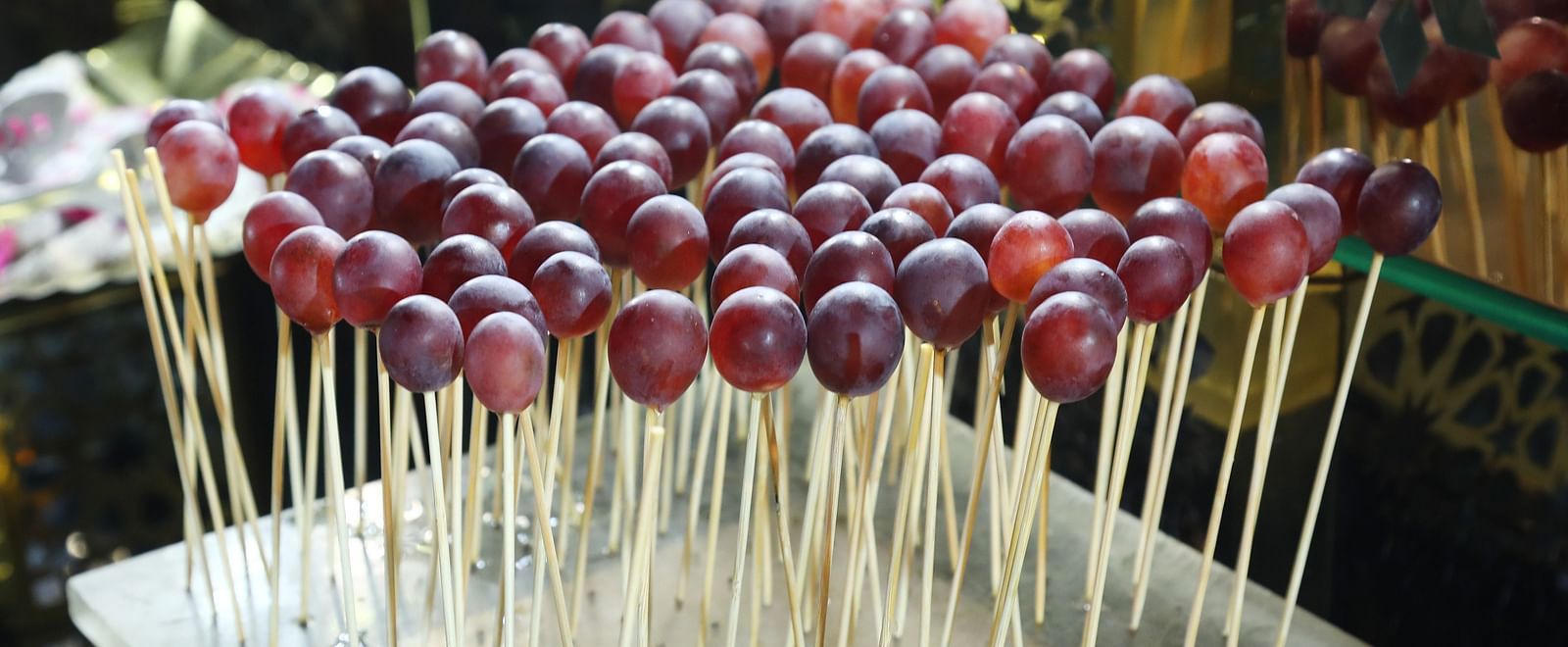 Skewers of red grapes arranged on a tray at Tisya Farms, Gurgaon.