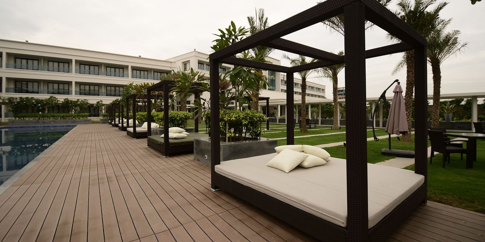  The lounge area beside the pool, featuring framed cushions for added comfort