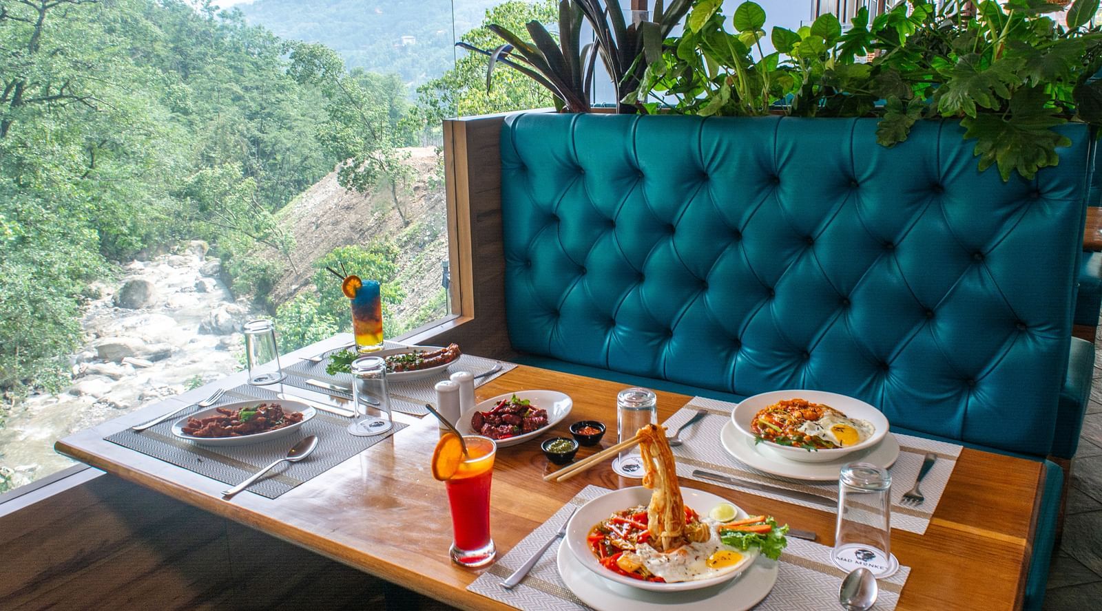 Image of a dining sapce with view of the river and nature surrounding it at Avianna Ganagtok Resort and Spa