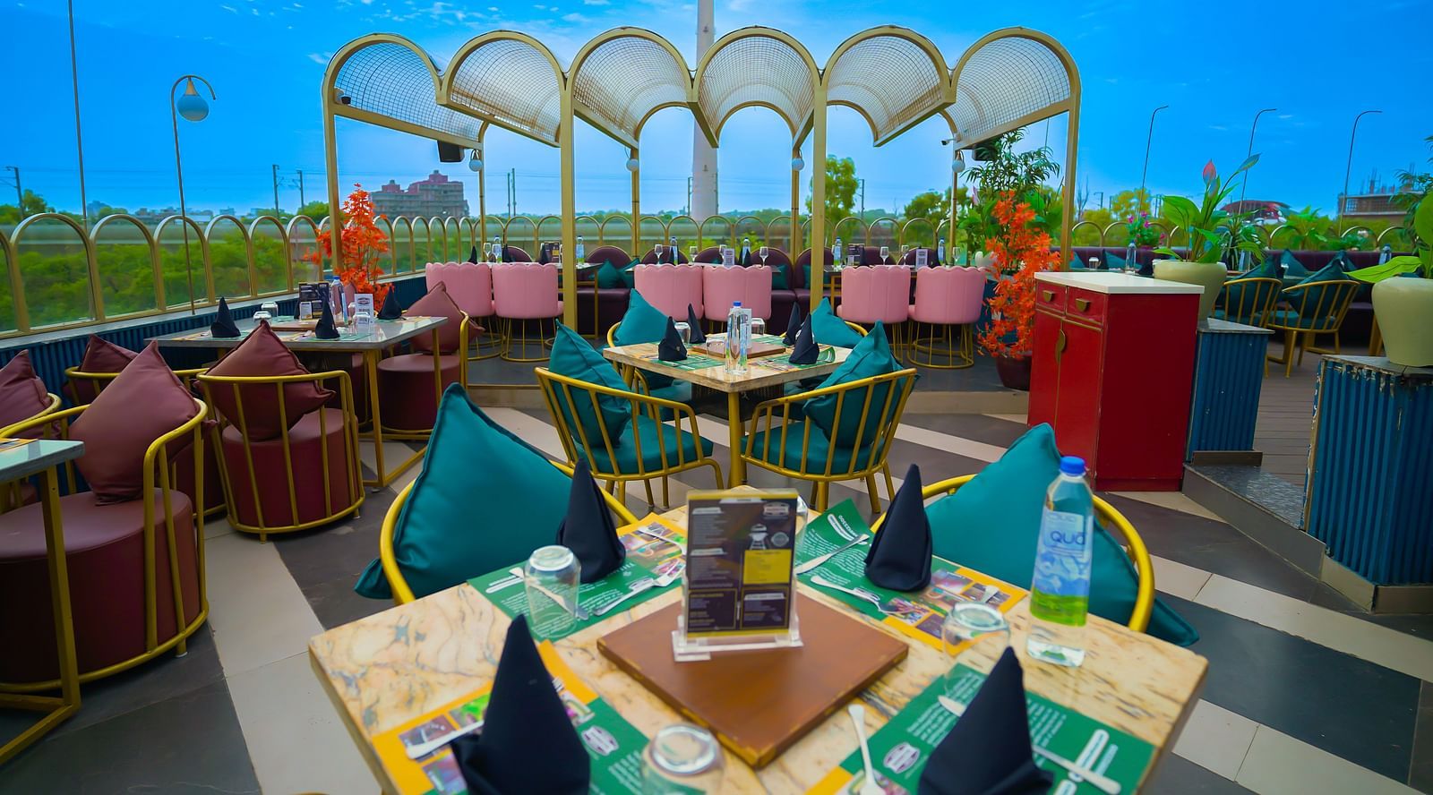 An image of a seating area featuring a four chairs and a table set at the terrace of Themis Barbecue House