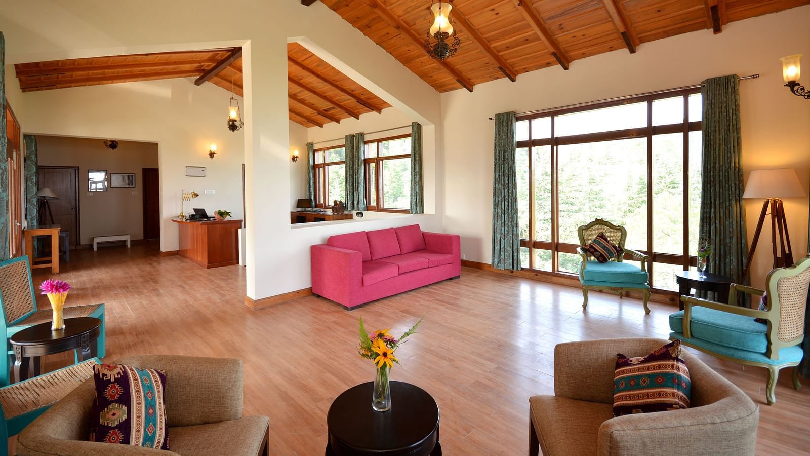 a lobby with, a wall-to-floor window, a teapoy, a pink sofa, wooden flooring, and teal coloured chairs - BluSalzz Escapade - Anant Rasa Resort