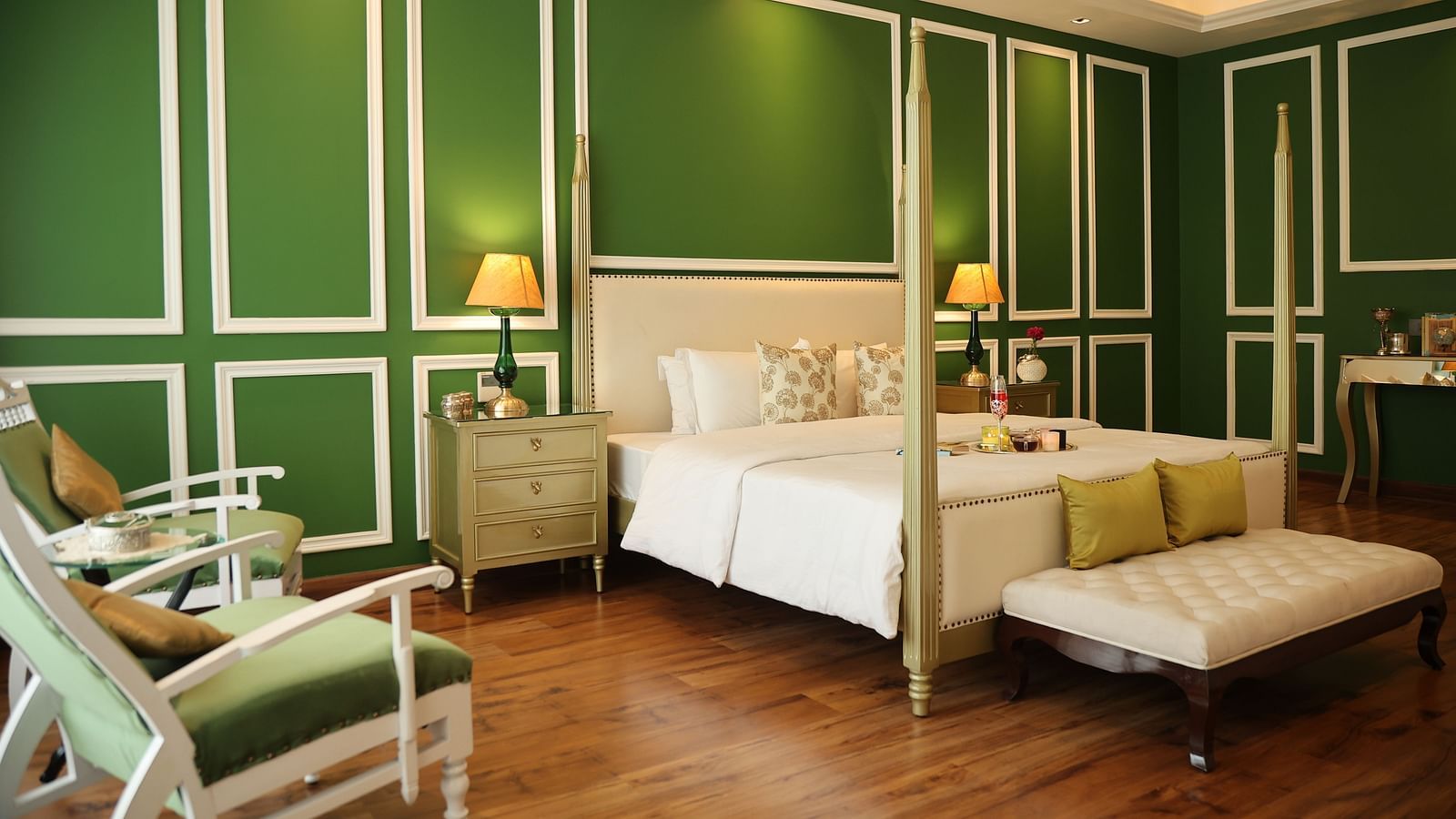 A room at Dileep Kothi, Jaipur with a double bed, side tables with night lamps and green walls