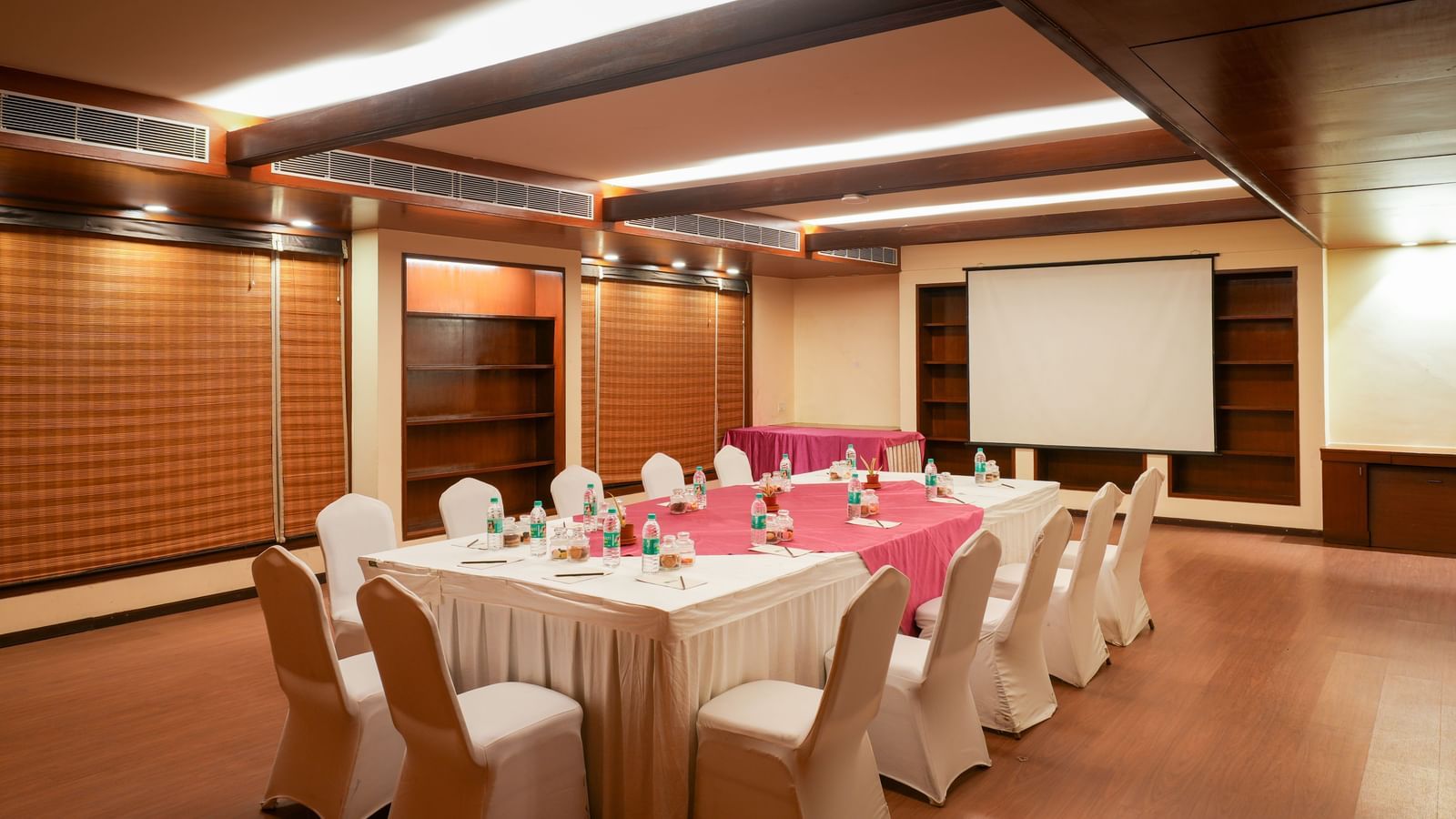 Private boardroom setup with projector screen at Vedic Village Spa Resort.