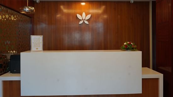 An image of a reception desk where a welcome note is placed along with a small bouquet at Five Elements Hotel, Jodhpur