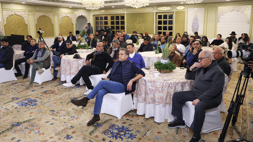 A group of people gathered in an event filled with several chairs and tables at Heritage Village Resorts & Spa