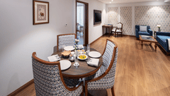 A round table set with food in the living room of our suite in Haridwar - MJ Sarovar Portico, Haridwar