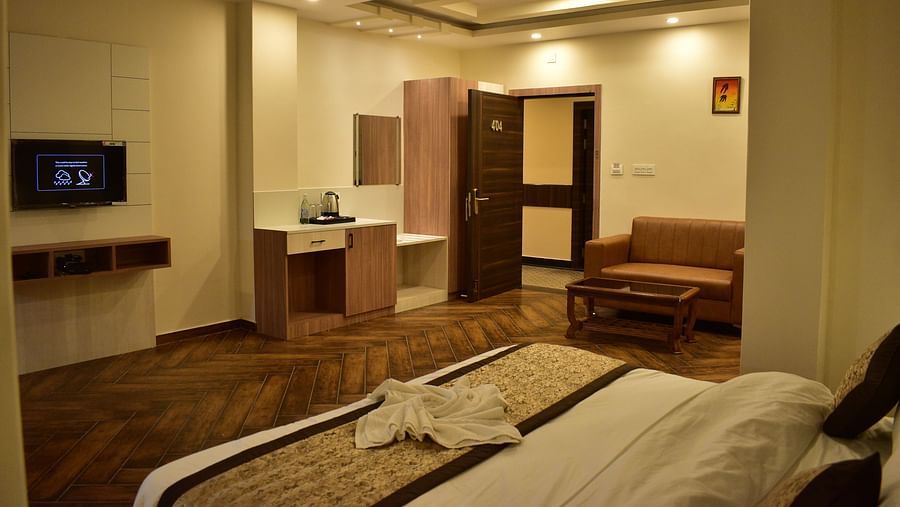 Deluxe Room - a pristine white bed with soft linens and clean pillows designed with soft lights and aesthetic interior2 - Hotel Montana Vyoo