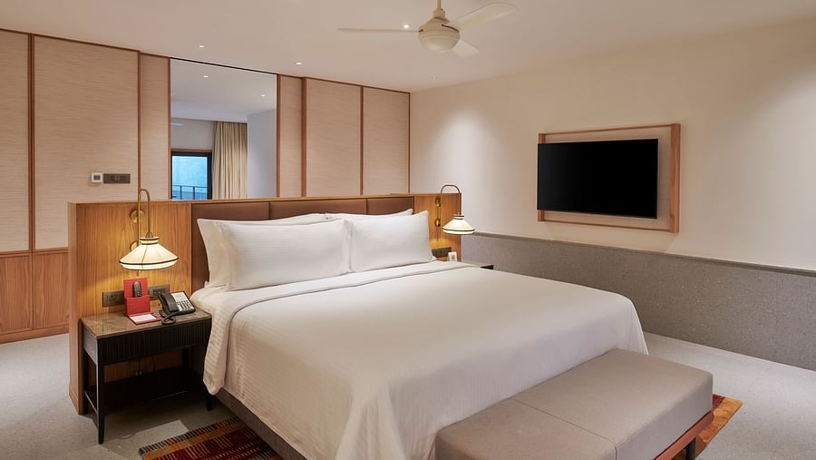 A bedroom with a comfortable king bed, a side table and a TV at The Dukes Retreat.