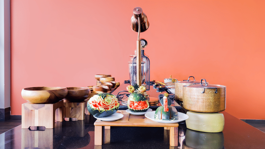 Colorful food spread with traditional serving vessels at Mount Himalayan Hotel & Spa restaurant.