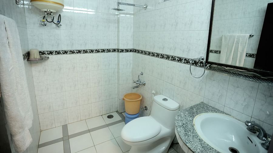Image of a washroom with a sink and a toilet at Amara Hill Queen, Mussoorie.