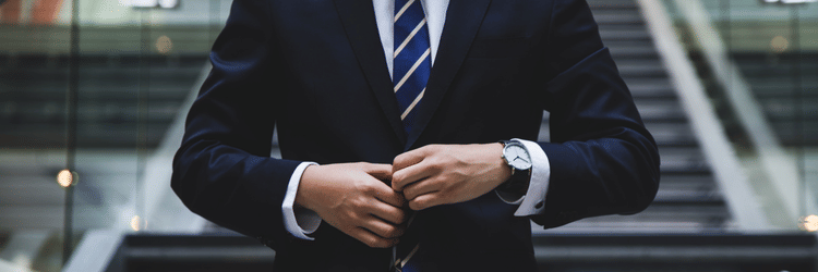 a man fixing his suit - V Five Hotel