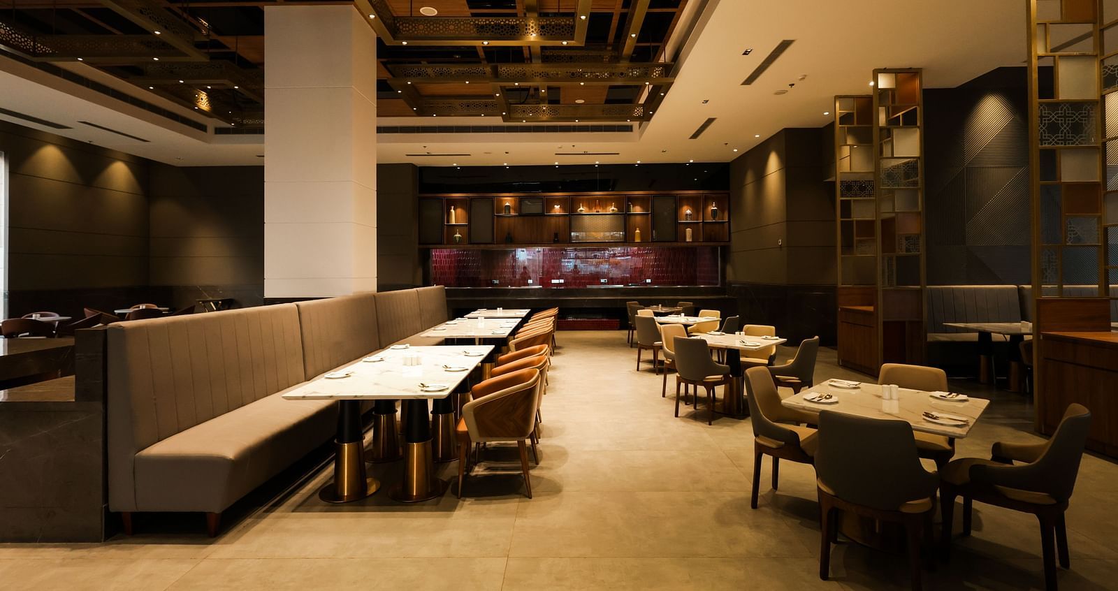 Spacious restaurant with wooden interiors and multiple dining tables at Ramada by Wyndham Sonipat Murthal