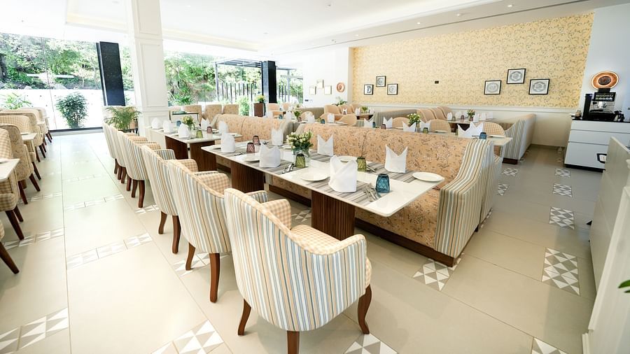 An image of a restaurant with upholstered chairs placed around ling dining tables - NAMAMI BY ZENQ BANKHANDI