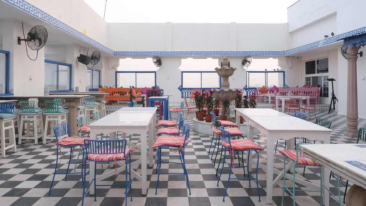 The elegant seating area of ta BLU Rooftop Bar at Clarks Amer, Jaipur