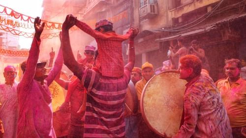 people playing with colours on the street with drums