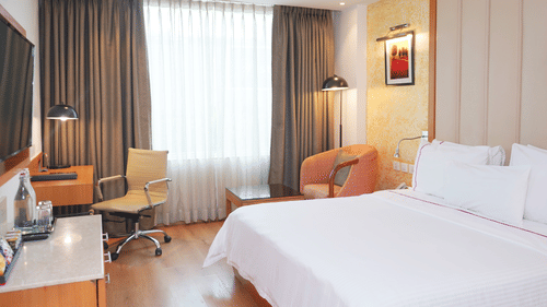 Comfortable standard room at Nemesia with a bed setup, a work desk, and a seating area.