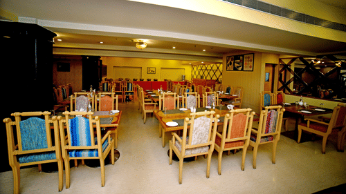 Dining area with multiple tables and chairs.