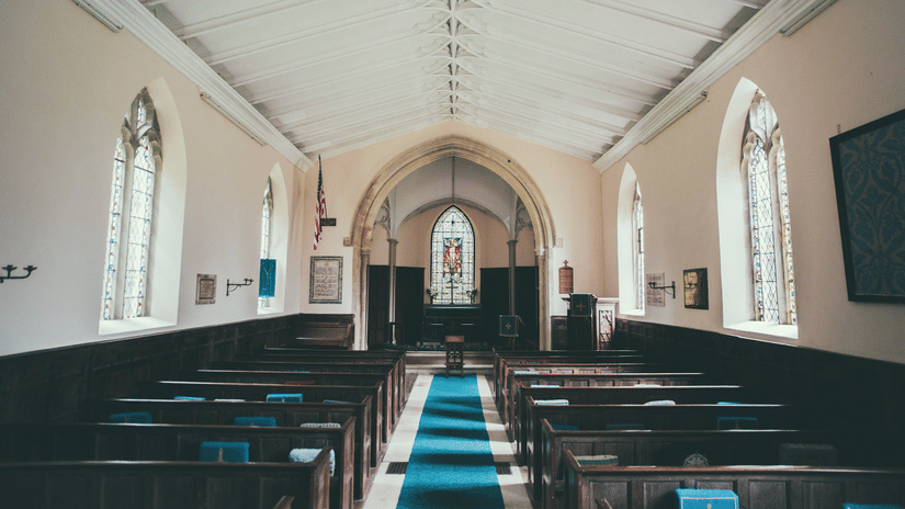 seating arrangements inside a chapel with the diaz in the background