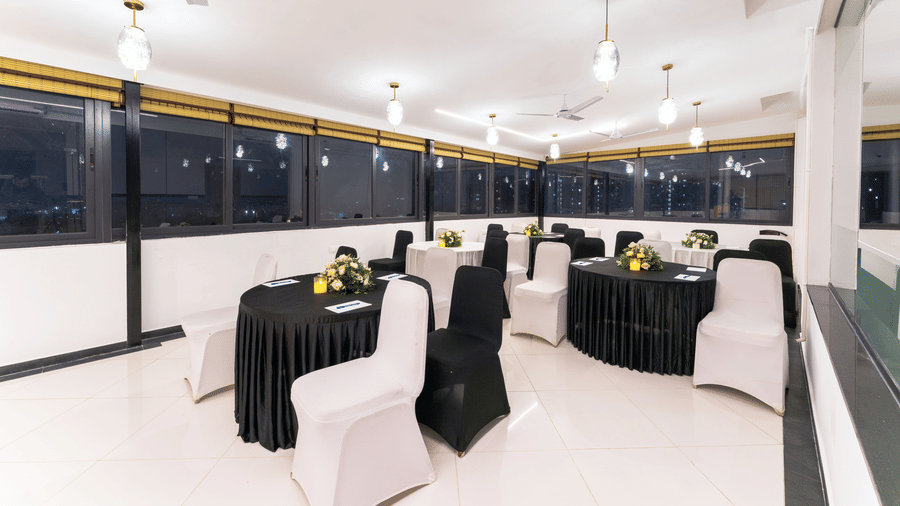 Elegant banquet hall set up for meetings and events with formal seating arrangement at Rivido - Manyata