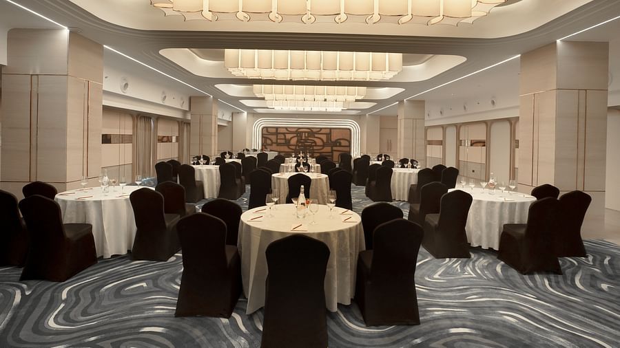 Formal event space featuring round tables with white linens and dark chairs. Sophisticated ceiling lights and a patterned floor - The Orchid Hotel, Chandigarh