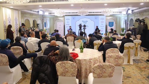 An image of a group of people gathered in an event filled with several chairs and tables at Heritage Village Resorts & Spa