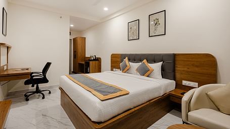 A corner view of cosy bedroom with sleek interiors at Lemonridge Hotels, IDPL Balanagar