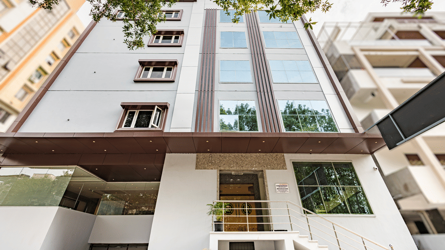 Exterior shot of the Lemonridge Hotels building with glass façade at IDPL Balanagar.