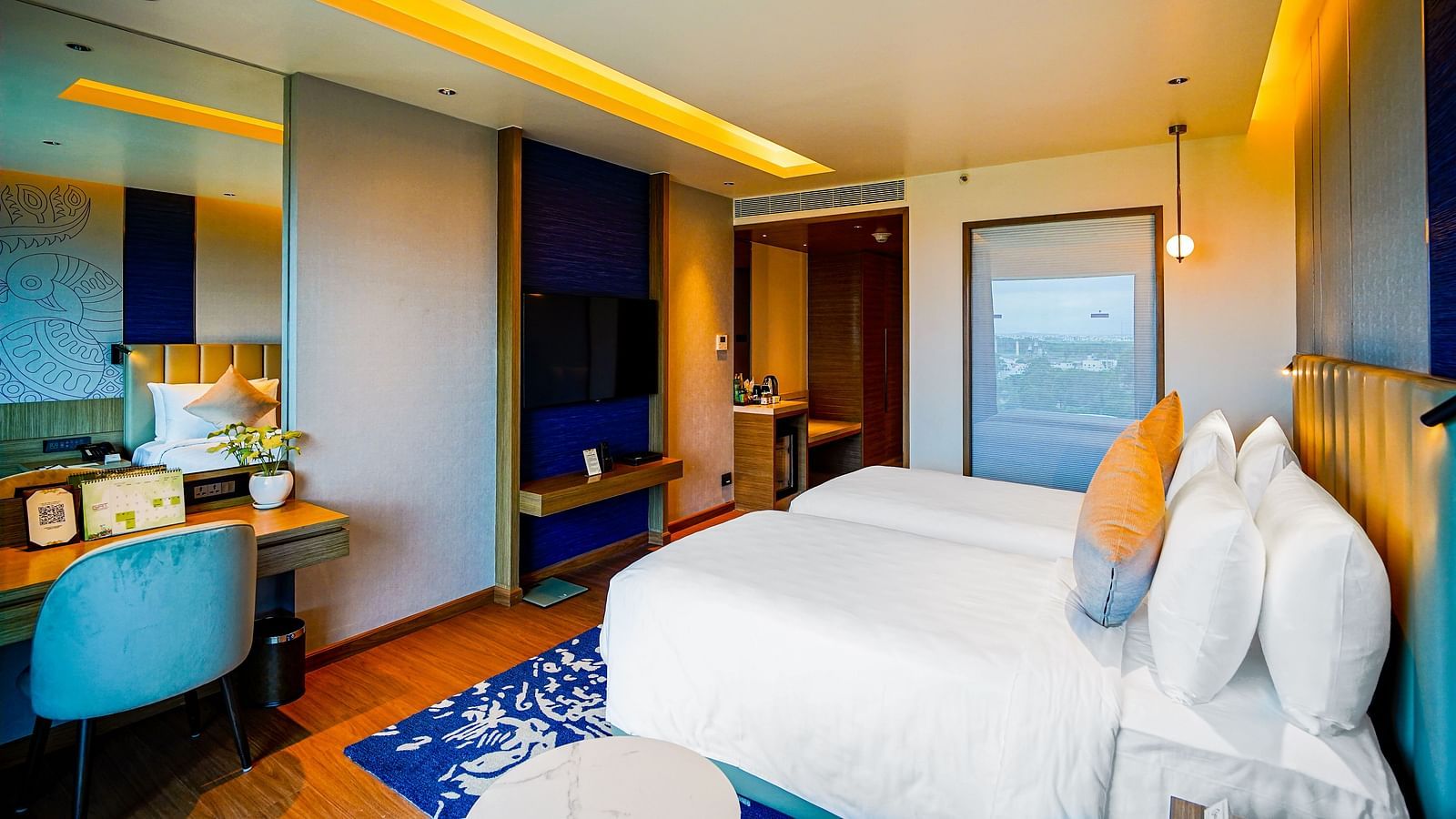 A Grand Club Temple View Room in Madurai with a twin bed, a work desk and hanging ceiling lamps - Grand Madurai by GRT Hotels
