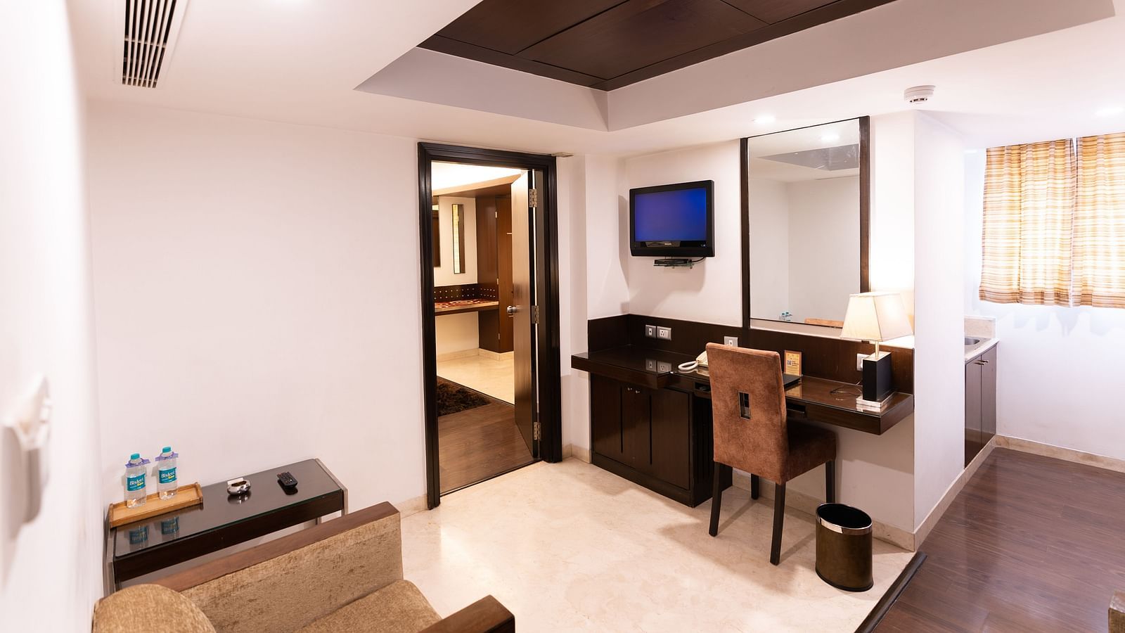 A cosy hotel suite with a sitting area, kitchenette, and modern amenities at The President Hotel, Jayanagar