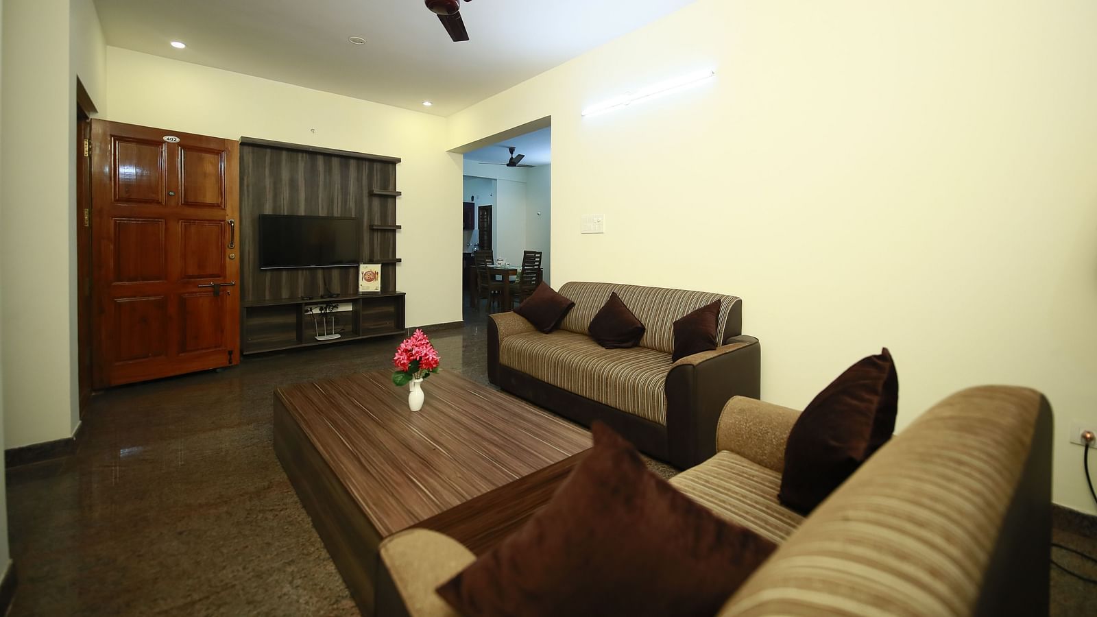 Living area with sofa seating and a coffee table at Tranquil ABS Orchid Serviced Apartments.