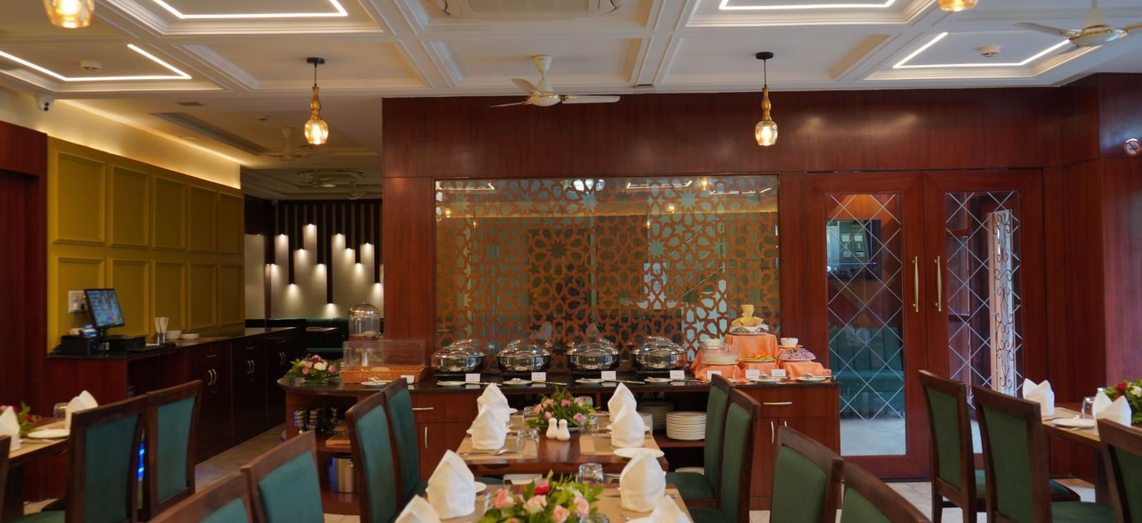 An elegant indoor dining room with multiple tables set for guests.
