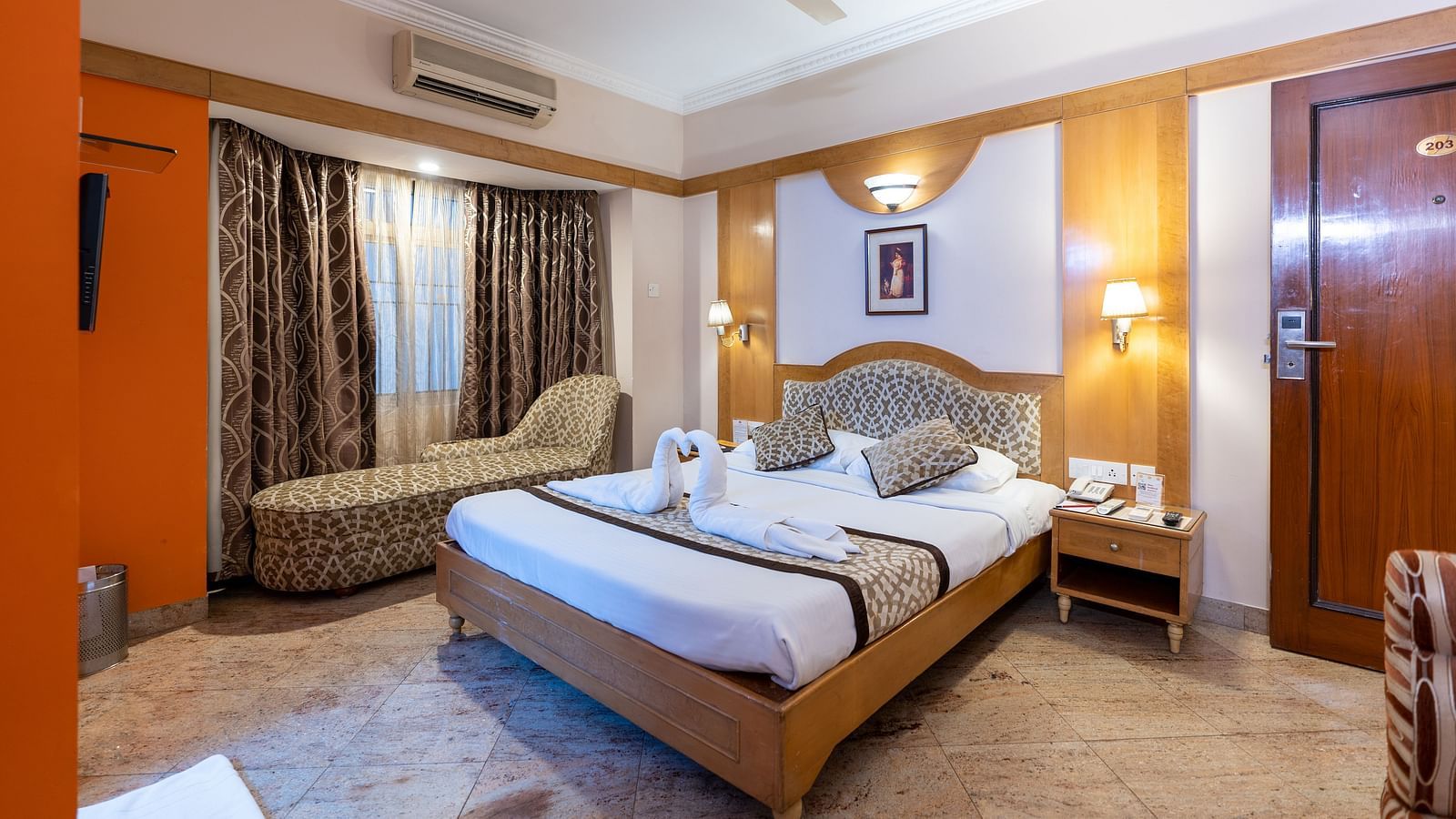 a double bed with a lamp above it inside one of the rooms - Hotel Pai Comforts, JP Nagar