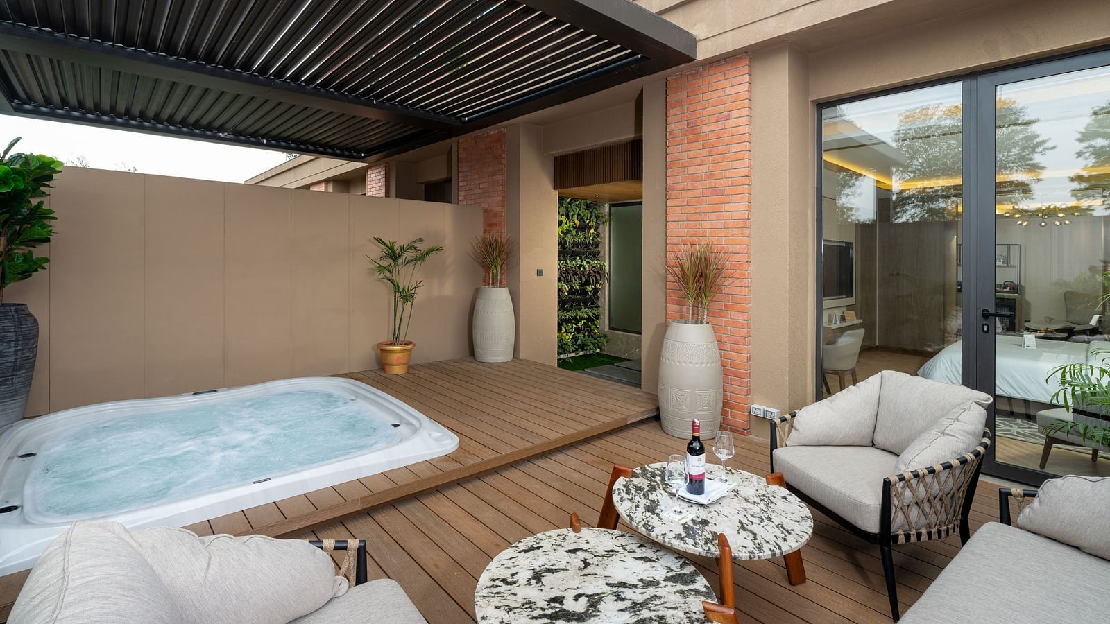 Private Nirvana Suite patio boasting a relaxing jacuzzi, comfortable outdoor seating, and a view of the hotel's surroundings - Nirvana Luxury Hotel, Ludhiana