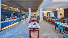 An image of a dining area with a buffet setup to the left and cosy tables towards the right - Sarovar Premiere, Amritsar