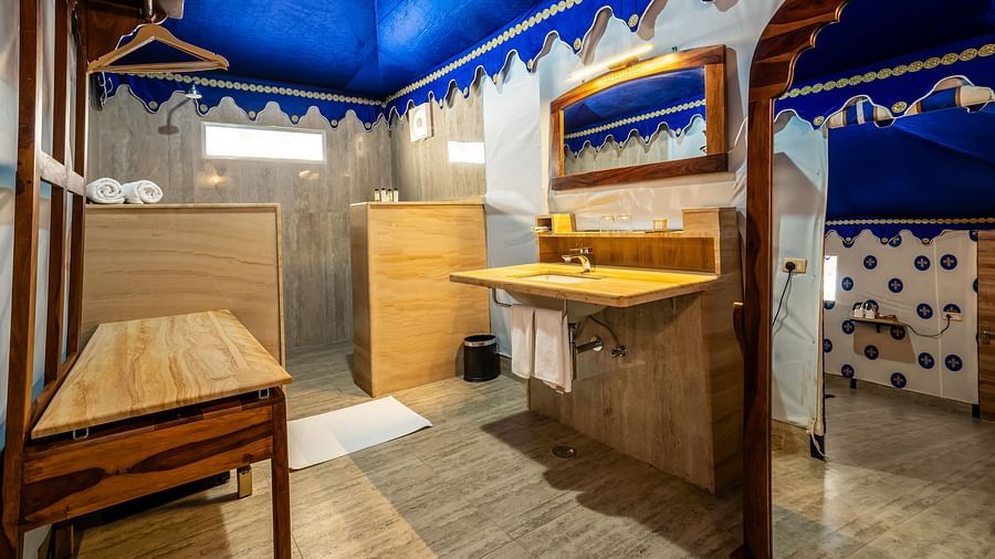 A modern bathroom at Buena Vista Luxury Garden Spa Resort with a sink, mirror, and shower area.