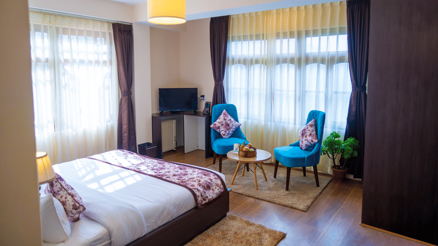 Dream Villa Retreat, Pelling - Interiors of the Premium Rooms with two bluw chairs and a coffee table made into a sitting area