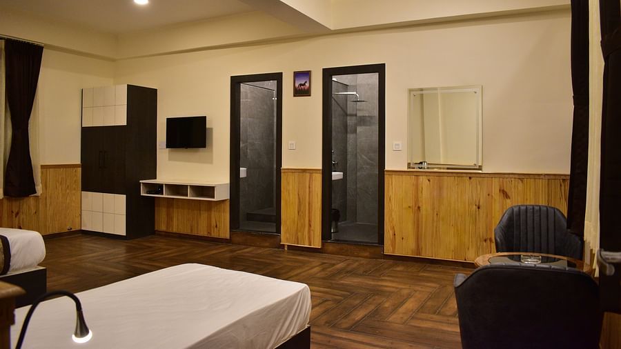 Deluxe Room Triple Occupancy - a luxurious room with a premium queen bed along with a single bed featuring room amenities like a wardrobe, television, a workdesk and more - Hotel Montana Vyoo
