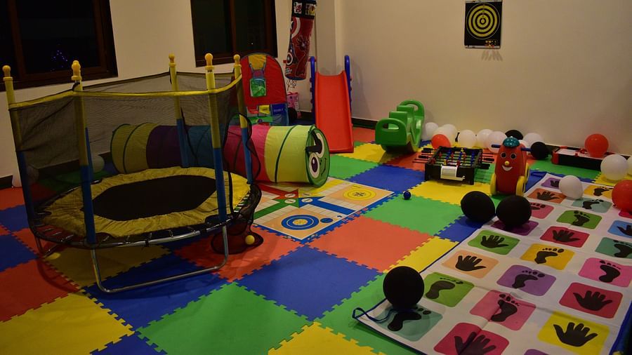 kids play area with toys and miniature rides with colourful flooring - Hotel Montana Vyoo