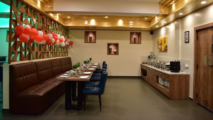 Hotel Montana Vyoo, Namchi Sikkim side angle view of dining table of a tea-seater dining table situted in front of the buffet area and decorated with red and white balloons - Hotel Montana Vyoo
