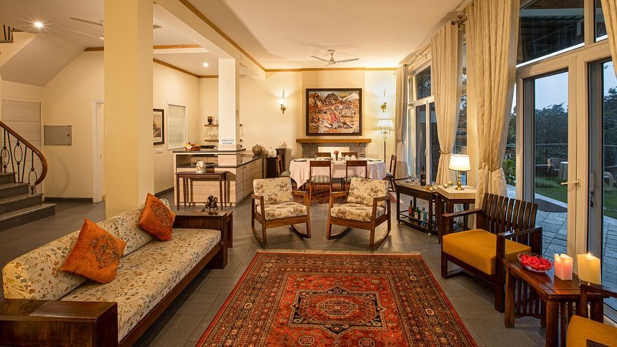Aesthetically designed living room with painted with pastel hues and features couches facing the outdoor landscapes1 - Lamrin Norwood Green Palampur