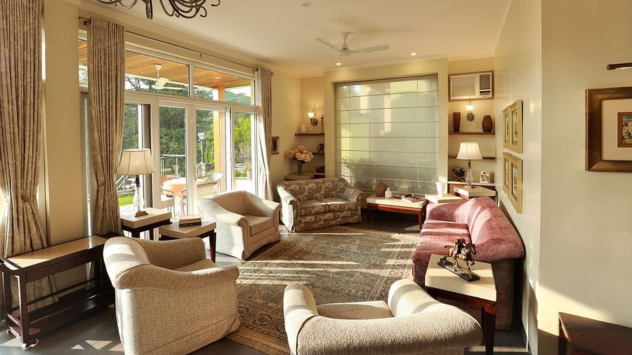 Aesthetically designed living room with painted with pastel hues and features couches facing the outdoor landscapes3 - Lamrin Norwood Green Palampur