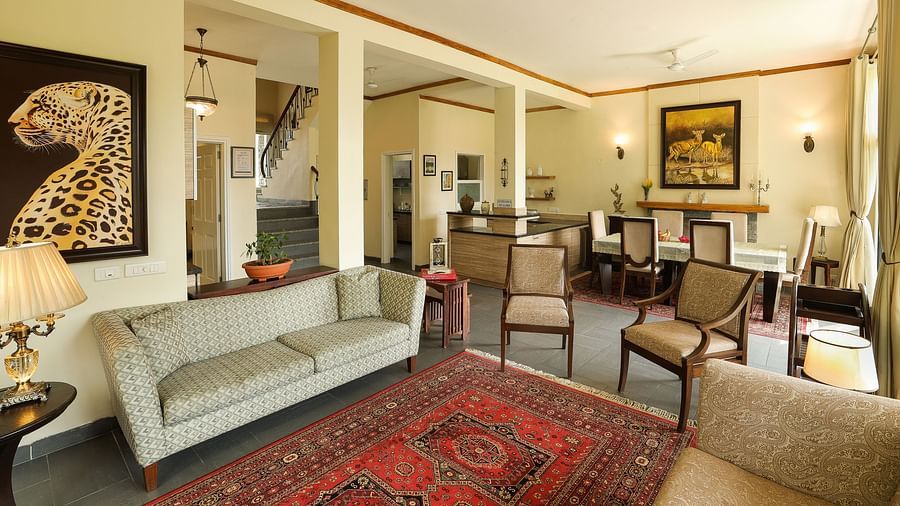 side angle view of a spacious living room with modern interior decor and large windows facing the tea gardensLiving RoomLiving Room1 - Lamrin Norwood Green Palampur