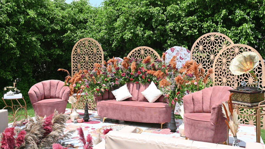 Outdoor wedding decor at Marasa Sarovar Premiere, Bodhgaya featuring pastel seating, floral arrangements, and arches set with trees in the background.