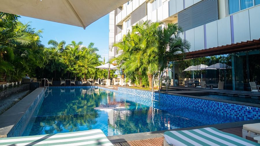 A crystal-clear swimming pool with a tranquil atmosphere at Neelkanth Sarovar Premiere Lusaka
