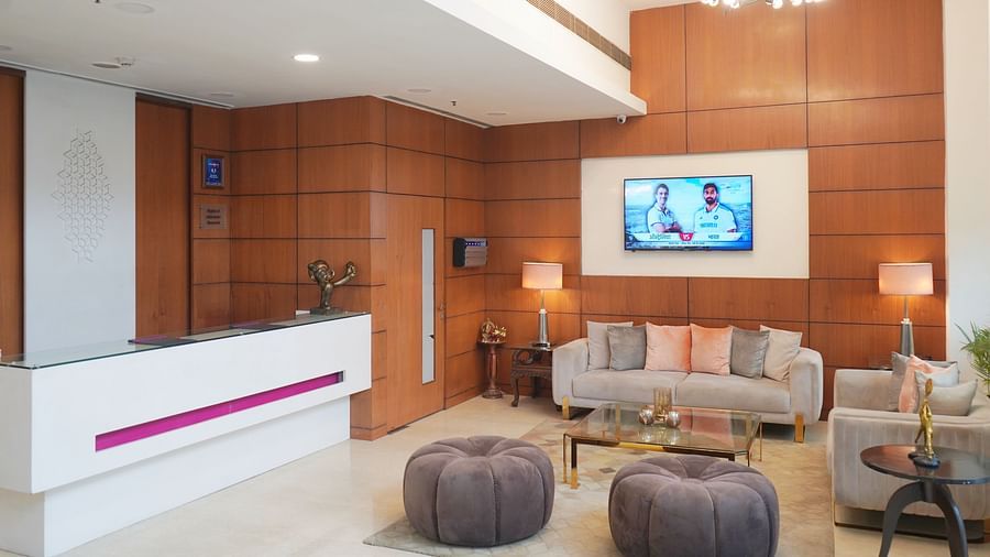 Elegant reception area at Nemesia with a stylish reception desk, comfortable seating, and a warm and inviting atmosphere.