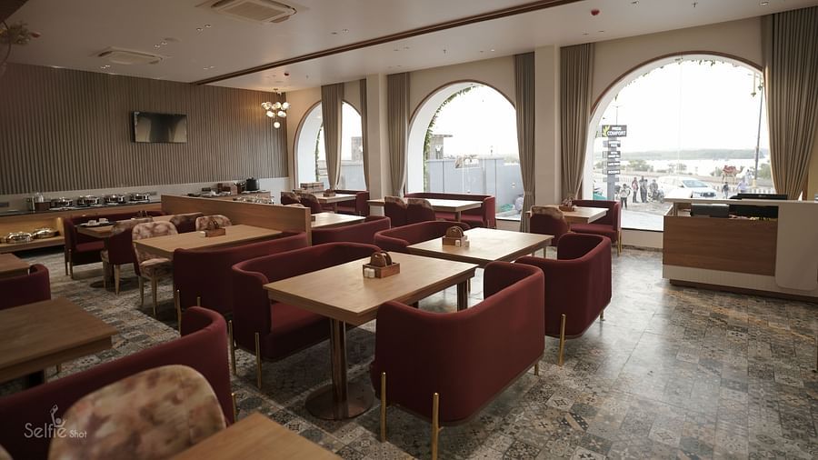 Seating arrangement in the restaurant at Pride Comfort, Dwarka
