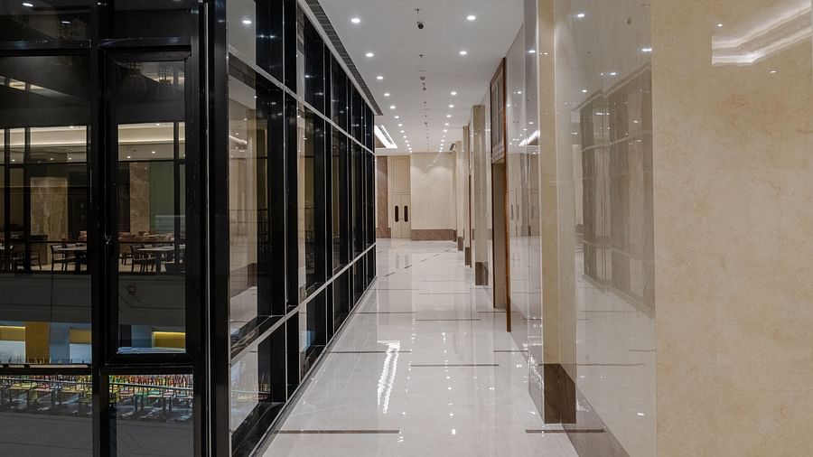 A corridor with tiled floors and ambient lighting at Sarovar Portico, Ajmer