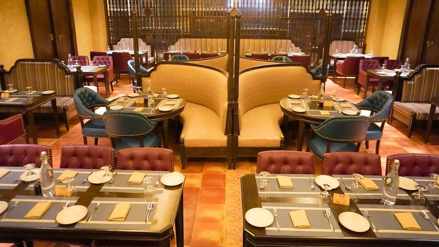 Refined restaurant setting displays formally set tables with place mats and glassware in a warm, inviting atmosphere - The Orchid Hotel, Chandigarh