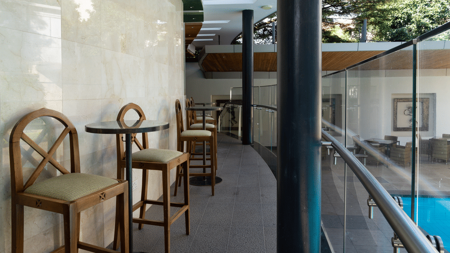 Outdoor corridor with balcony seating overlooking the pool at The Zehneria, Nairobi